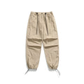 Man wearing loose straight leg casual trousers in lightweight nylon fabric, available in multiple colours.