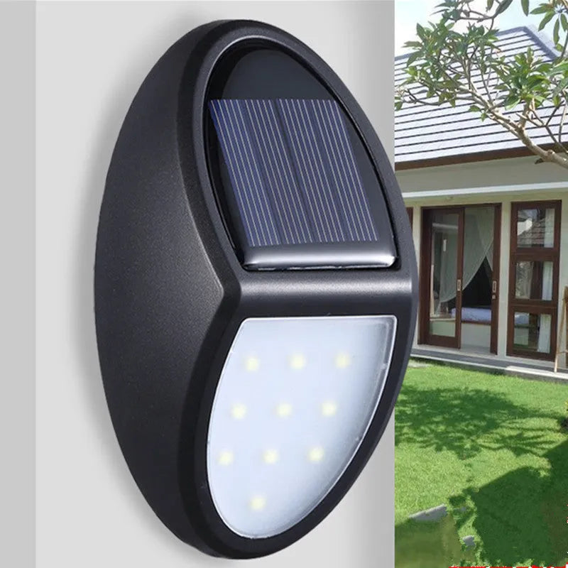 Black solar-powered LED wall light with motion sensor for outdoor security and garden lighting