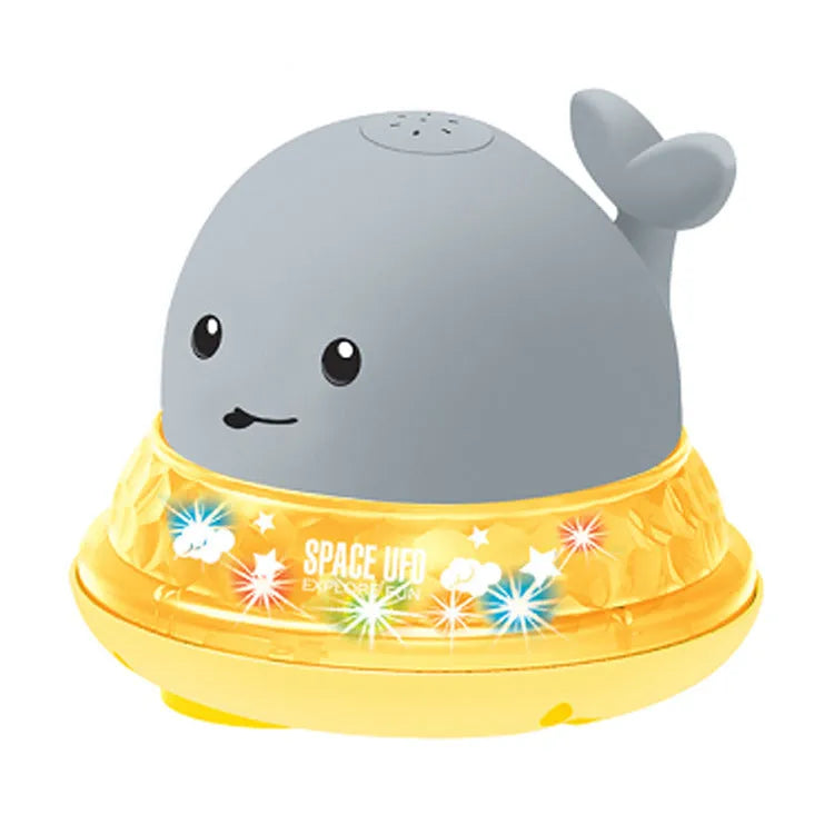 White and blue whale bath toy spraying water with LED lights illuminated