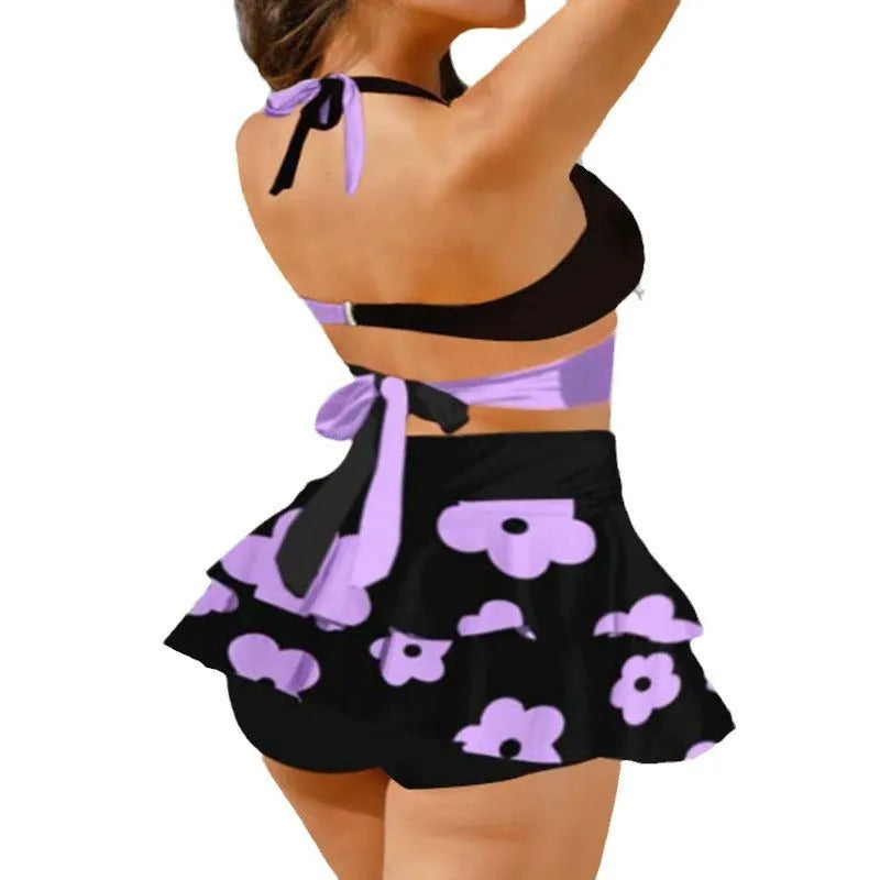 Purple and black women's bikini set with lace-up front and high-waisted split skirt.
