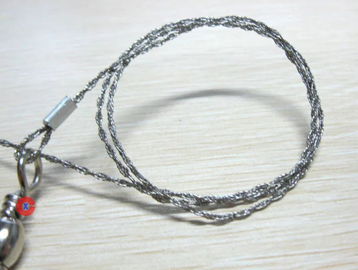 Survival wire saw with stainless steel blade and thumb rings for outdoor cutting tasks