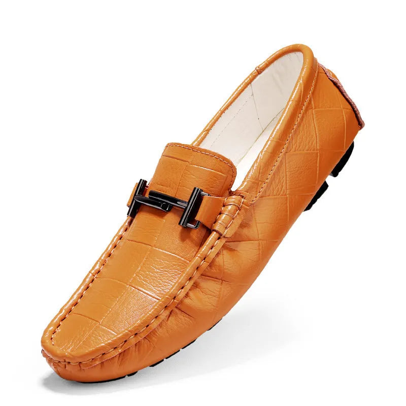 Men's brown leather slip-on loafers with a silver belt buckle detail on the front.