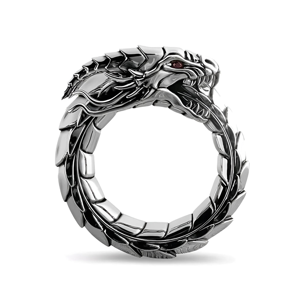 Vintage dragon male ring in ancient silver metal on a plain background.