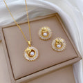 Women's geometric jewellery set with square diamond accents, ring and leaf motif on necklace and matching stud earrings.