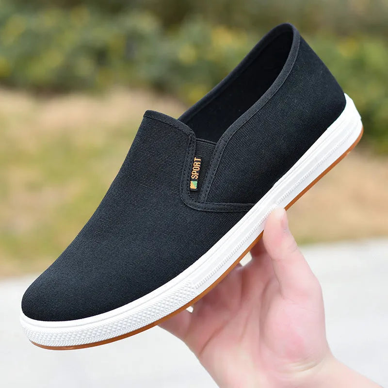 Men's black and blue slip-on canvas trainers with round toe and shallow mouth design