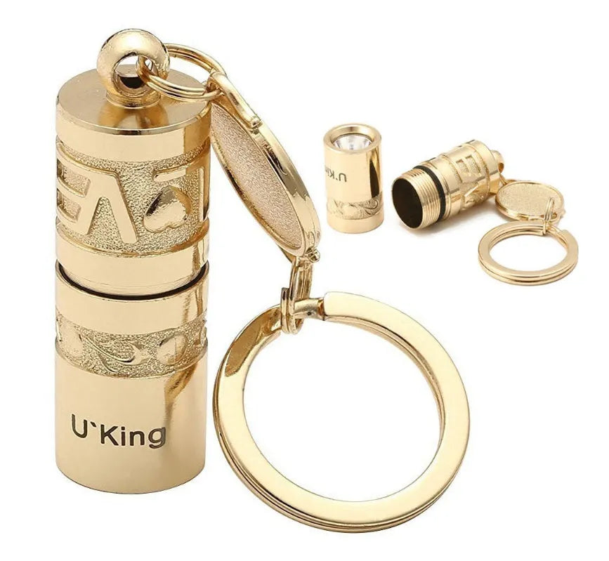 Gold zinc alloy mini LED keychain flashlight with a waterproof case and emergency light function.
