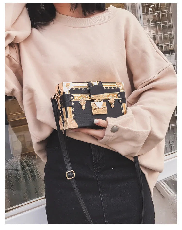 Hard structured black PU leather women's shoulder bag with decorative rivets and single adjustable strap