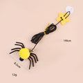 Red and yellow cat toy with feather and bell spider hanging from a door on an elastic rope.