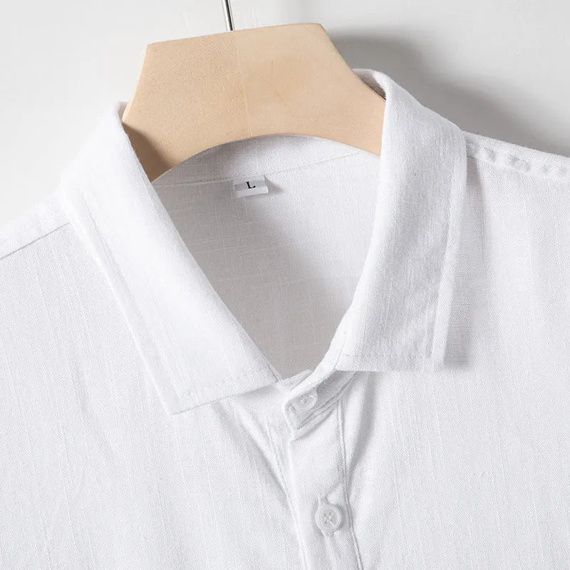 Man modelling a loose-fit linen blend T-shirt in a solid colour.