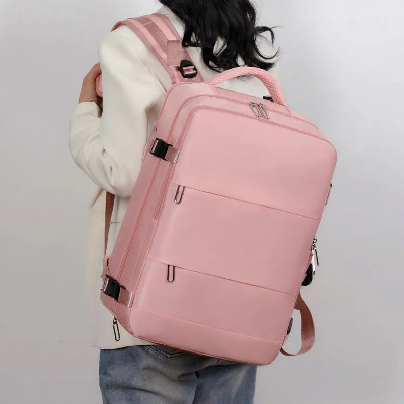 Large grey travel backpack with multiple pockets and an air pillow belt, shown open to reveal internal organisation.