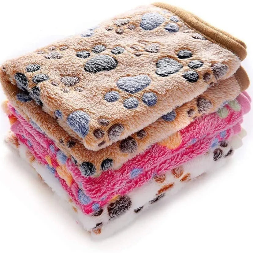 Coral fleece pet blanket with dog paw print pattern in beige, shown alongside size options from small to extra large.