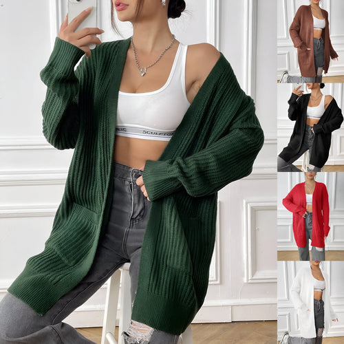 A loose-fitting, mid-length acrylic cardigan sweater in a solid colour, shown in a street hipster style.