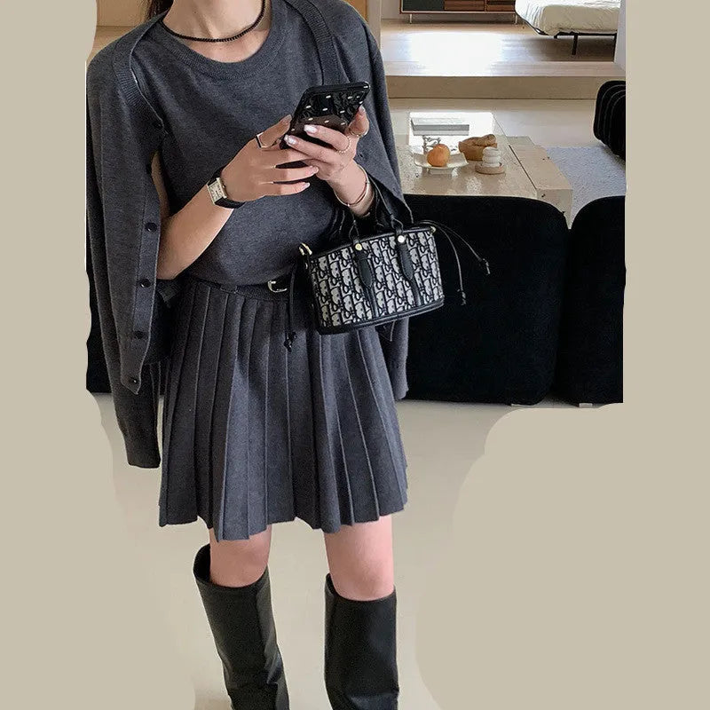 Grey women's art retro knit two-piece set featuring a pleated vest skirt with belt and a long-sleeved cardigan.