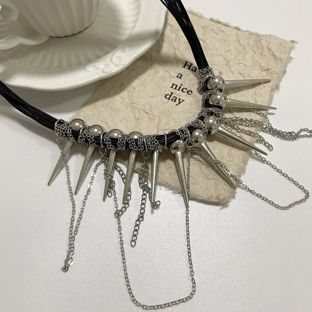 Round beads winding tassel necklace with leather fringe and metal rivet embellishments in picture colour.