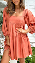 Orange backless children's dress with puff sleeves, a square collar, and a loose A-line skirt.