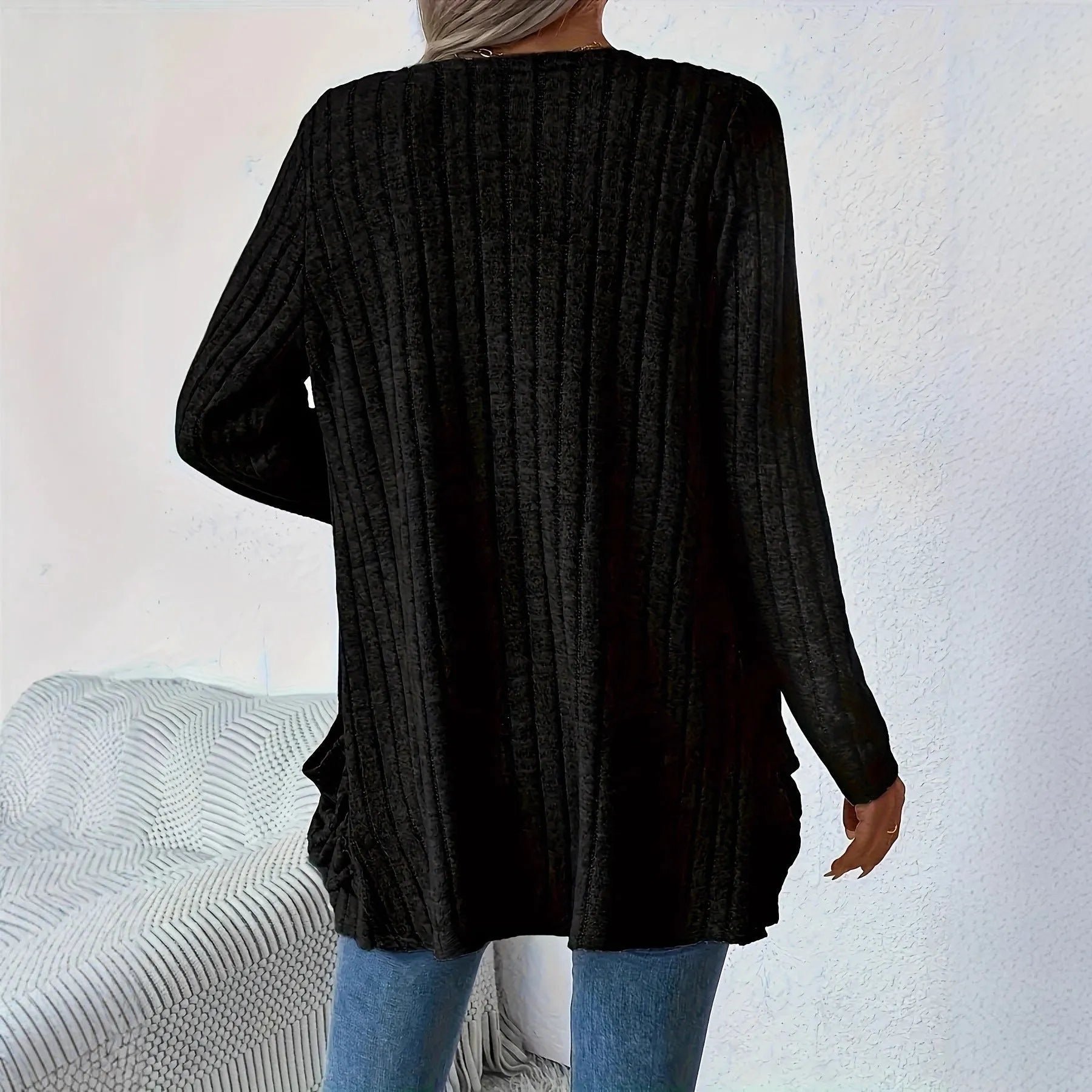 Long sleeve loose fit cardigan in grey with a pocket, shown on a hanger.
