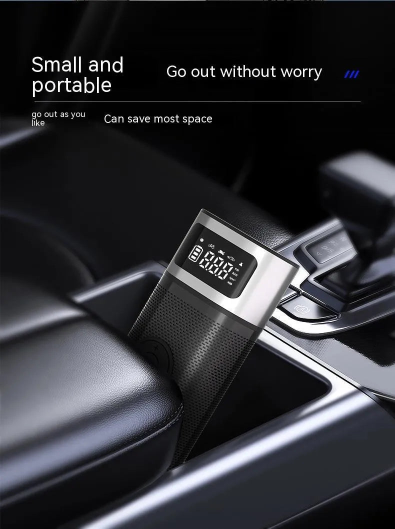 Black portable wireless smart vehicle air pump with hoses and nozzles on a storage bag.