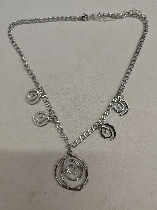 Spiral donut jewellery set showing necklace, bracelet and earrings in gold colour with geometry shapes