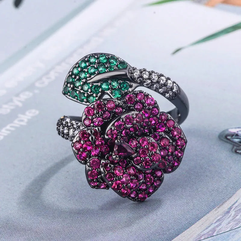 Women's geometric flower ring in black gold with simulated red corundum stone on gold-plated copper band