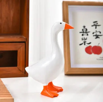 White simulated duck magnetic resin ornament on a fridge door