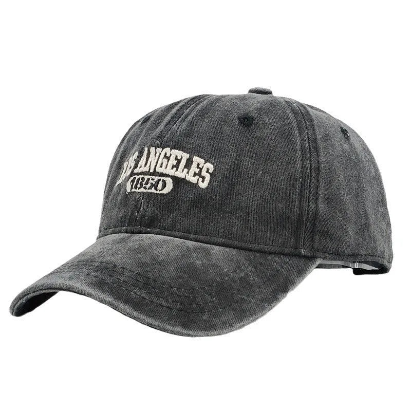 Retro-style adjustable acrylic peaked cap with embroidered letters, shown in a distressed beige colour.