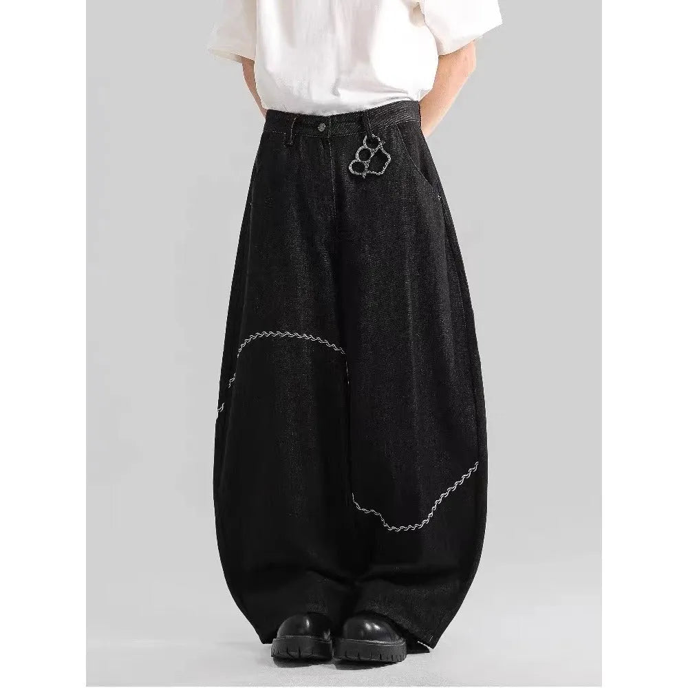 Black straight-leg men's trousers with a mid-waist and zip fly on a hanger.