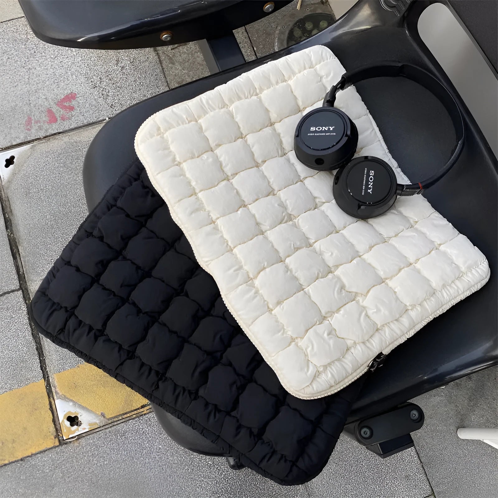 Black nylon laptop backpack open to show dedicated computer compartment with cloud cotton shoulder straps
