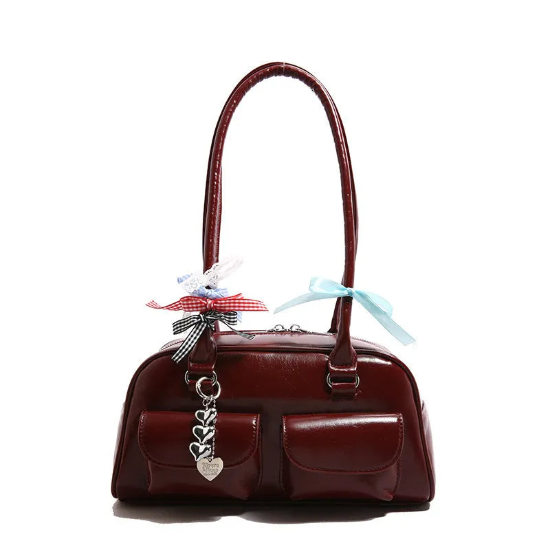 Retro pillow-shaped PU leather women's handbag with double shoulder strap in black colour with ribbon pendant