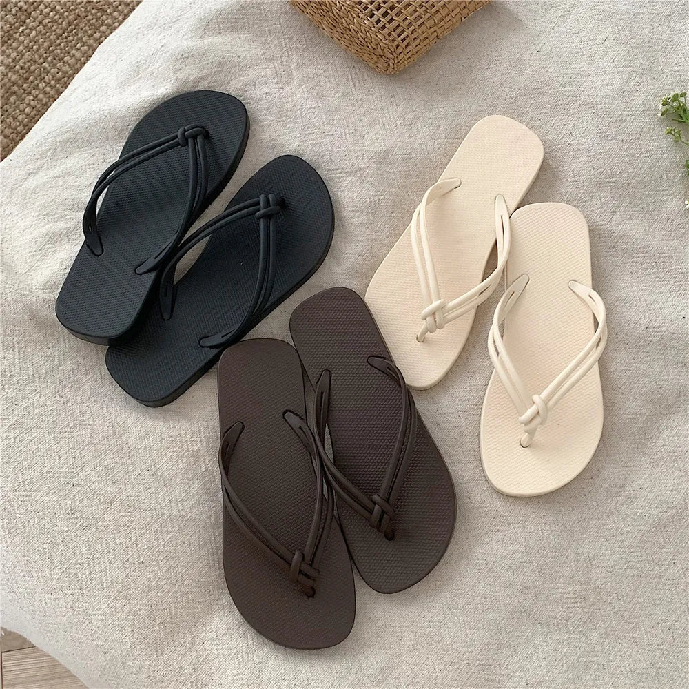 Men's PVC toe-covering flip flops on a solid colour background, showing the non-slip sole and range of available colours.