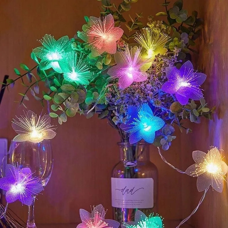 LED optical fiber flower light string with 20 warm white beads and plastic shell, battery powered, available in 1.5m to 100m lengths.