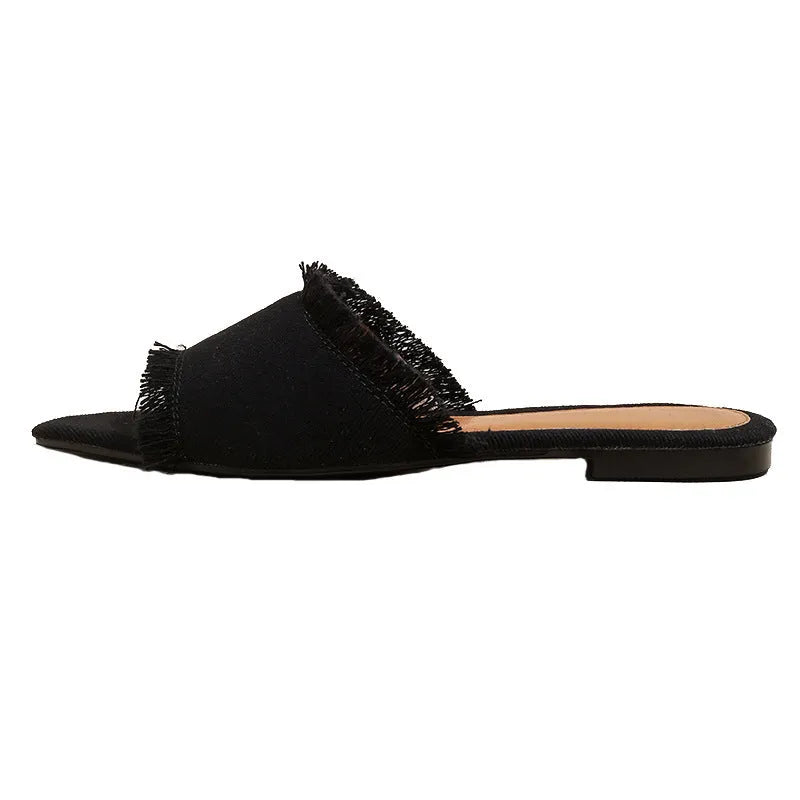 Women's denim casual flat slipper with tassel detail in various colours on a white background.