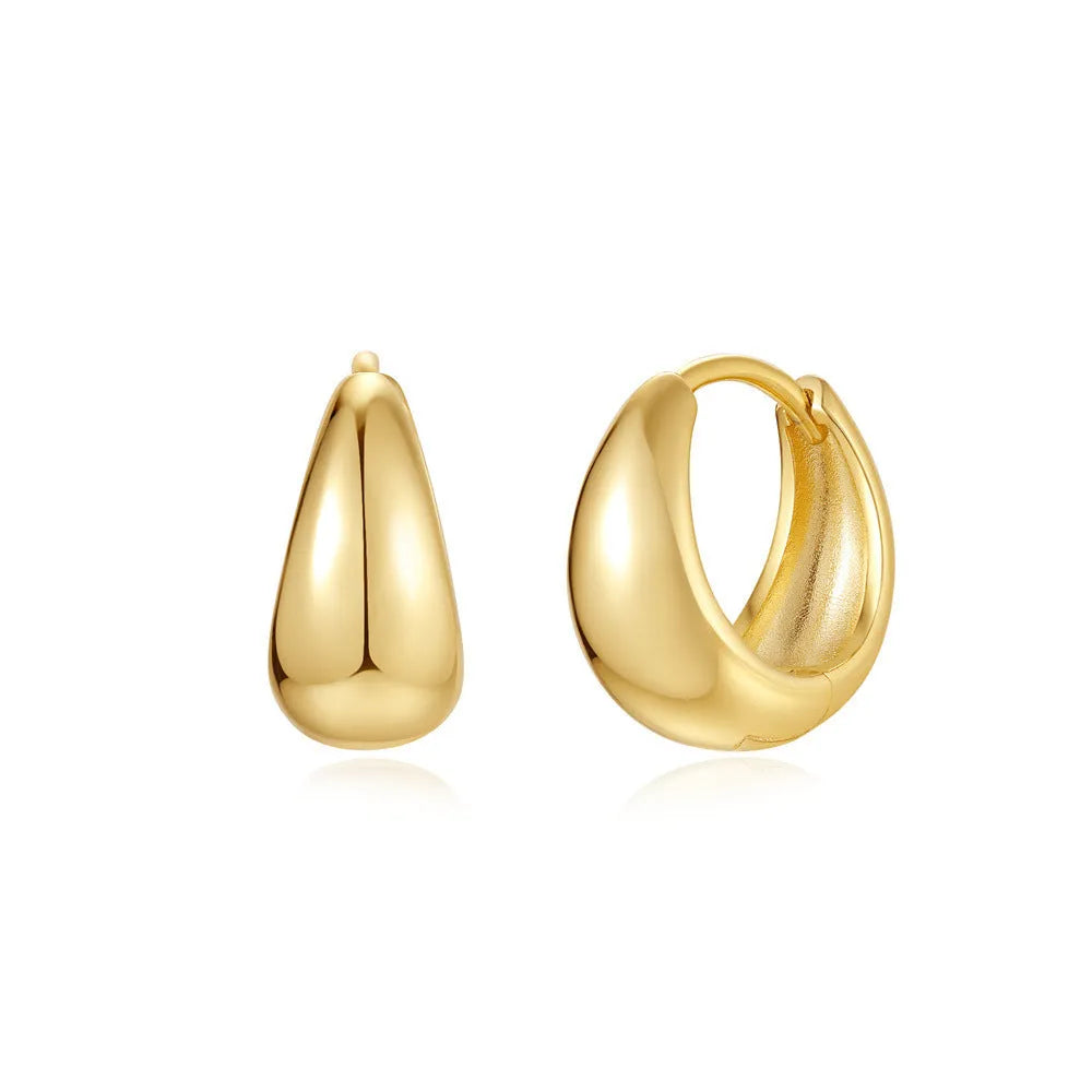 Golden brass diamond earclip earrings with simple geometric round design on white background