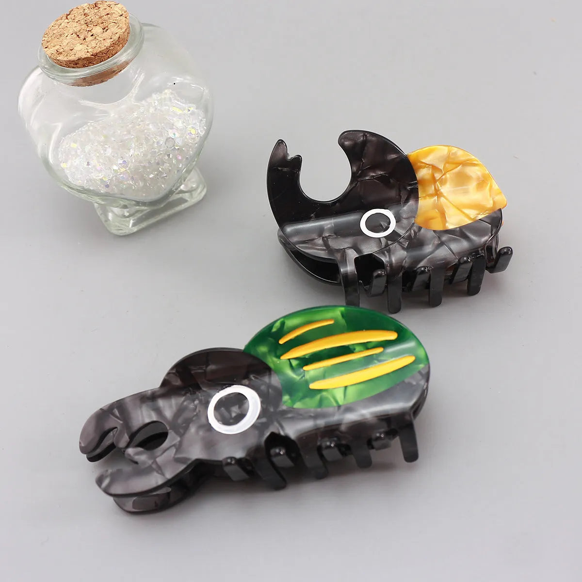Handmade green and orange cellulose acetate beetle grip with white caterpillar cartoon design