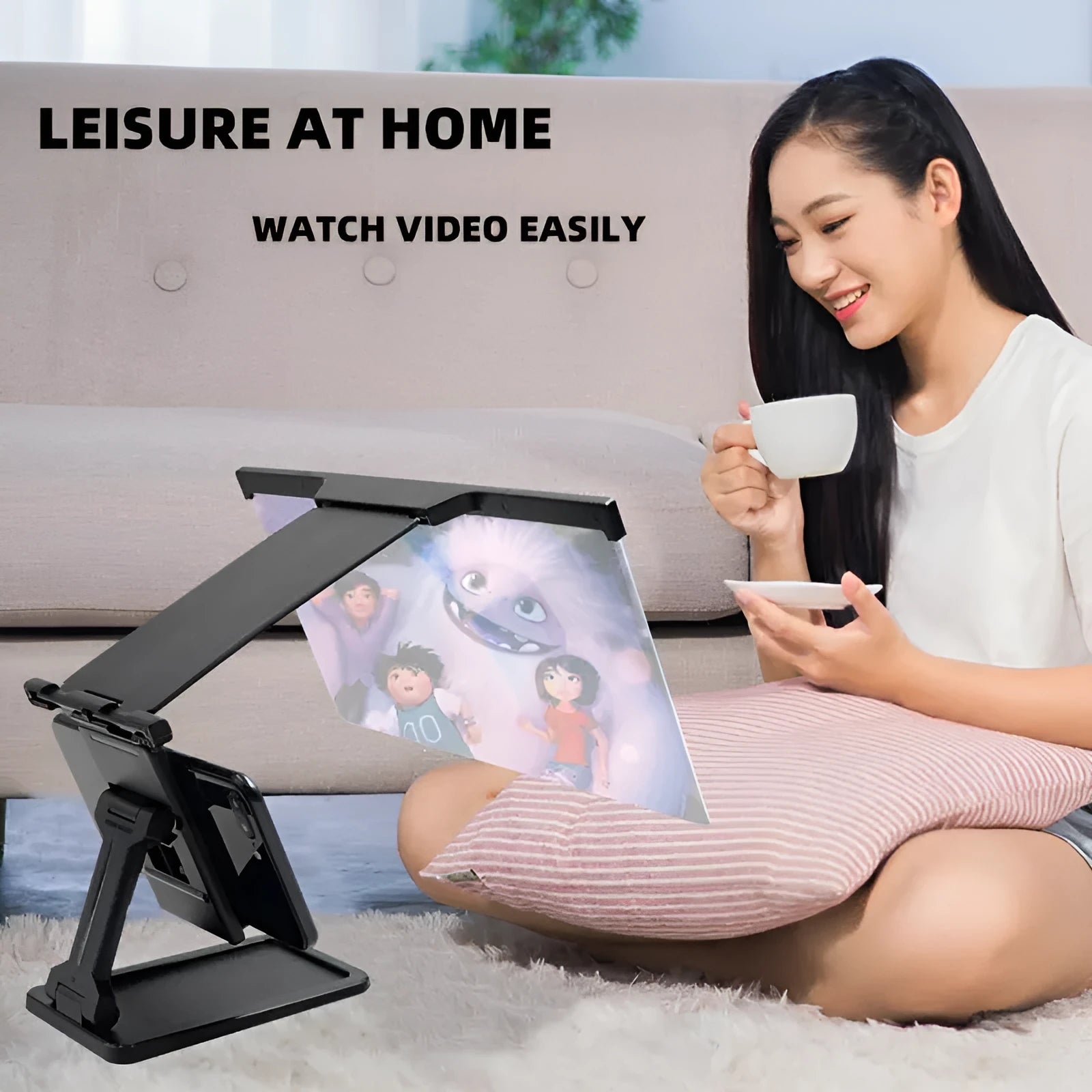 Black folding mobile phone screen amplifier with detachable holder on desktop