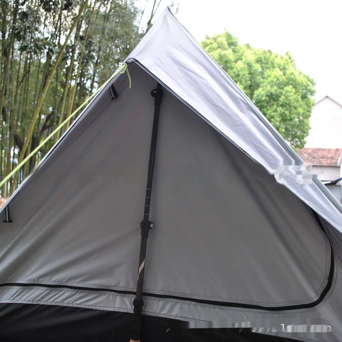 Brown A-line pole-free cabin tent set up with hiking poles showing spacious interior for 2-3 campers