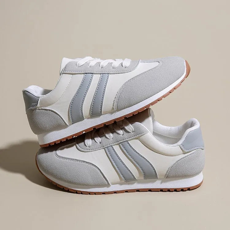 Blue and grey leisure sports shoes with Cortez stripes pattern, flat rubber sole, and round toe design