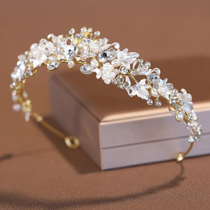 A gold-coloured alloy crown headdress for women with glass pearl decorations on a model's hair.