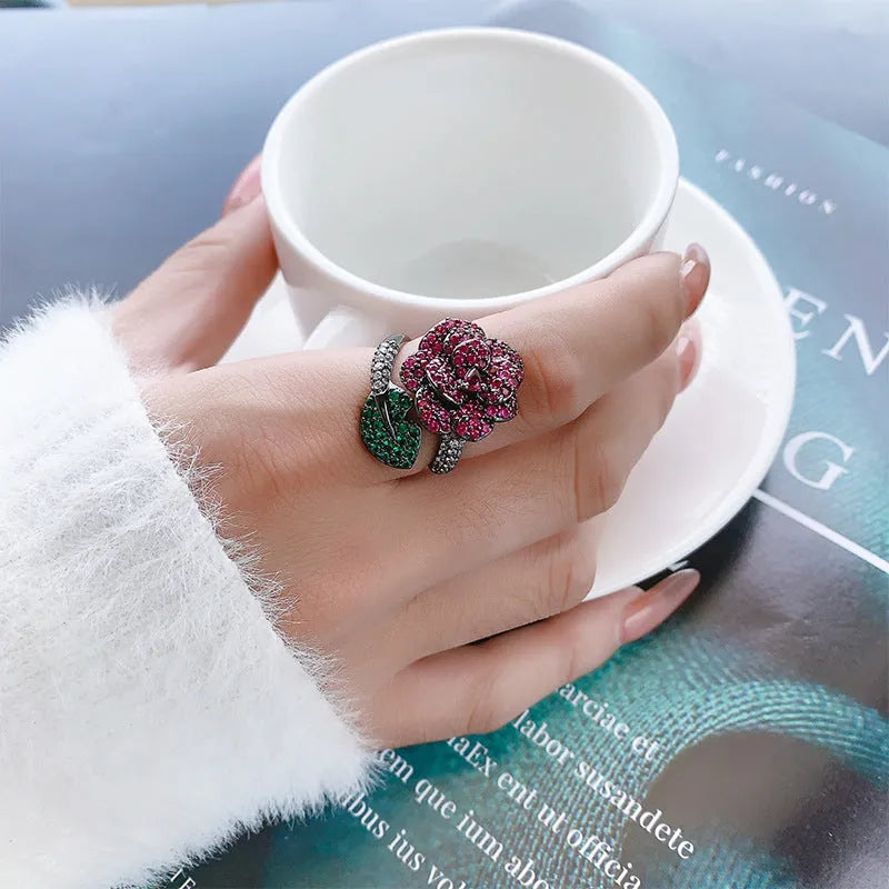 Women's geometric flower ring in black gold with simulated red corundum stone on gold-plated copper band