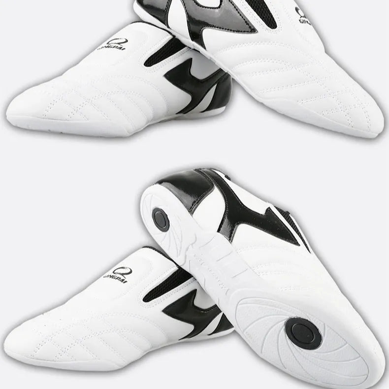 Black and white children's martial arts training shoes with soft bottom construction and widened design