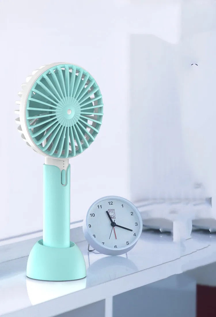 Blue handheld mini USB desktop fan with three speed settings showing compact design
