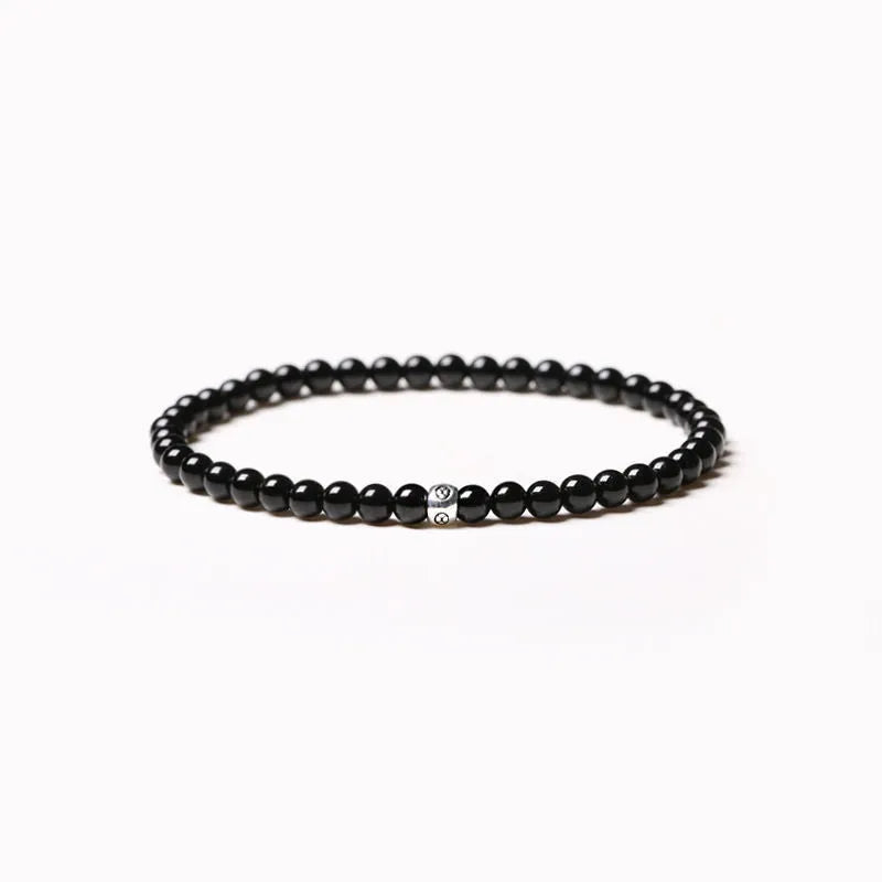 Geometric agate bracelet with black, blue, and obsidian 4mm beads and electroplated finish
