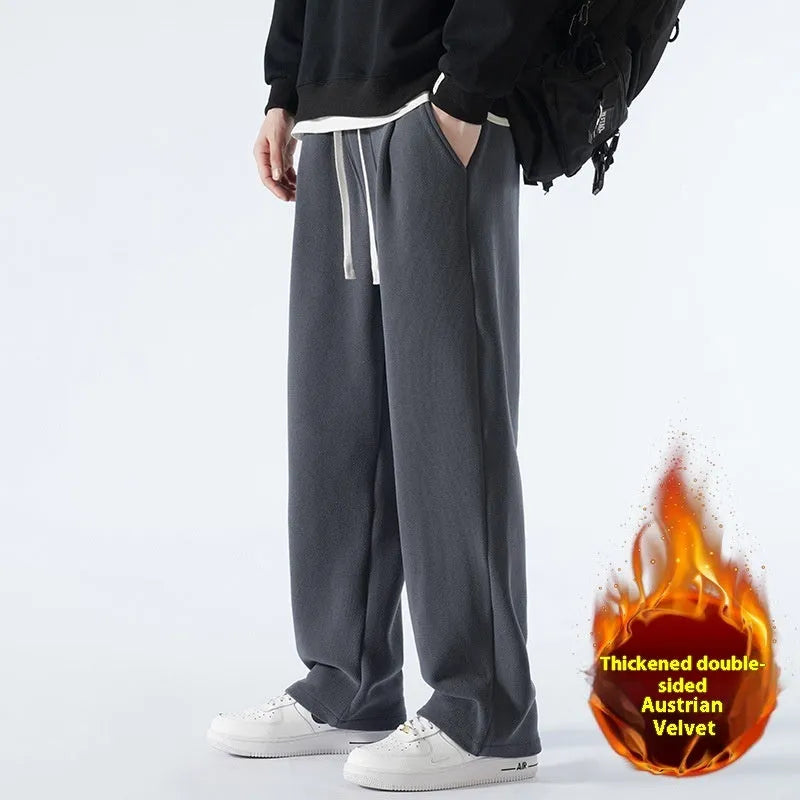 Men's apricot coloured loose-fit fleece-lined winter sports trousers with a drawstring waist laid flat.
