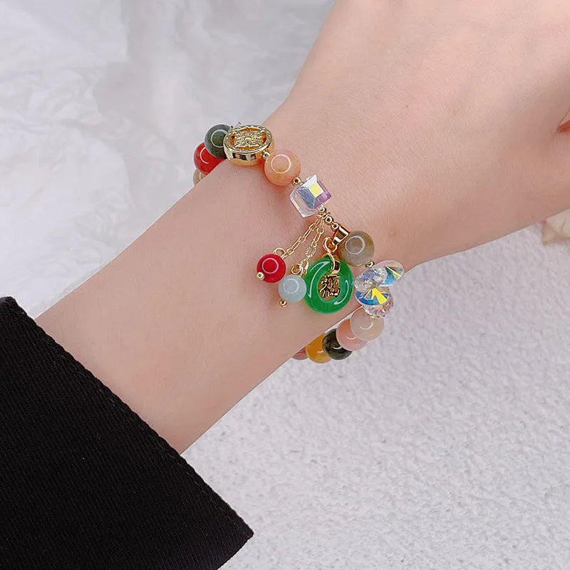Retro jinsi jade bracelet with fu character blessing card pendant against neutral background