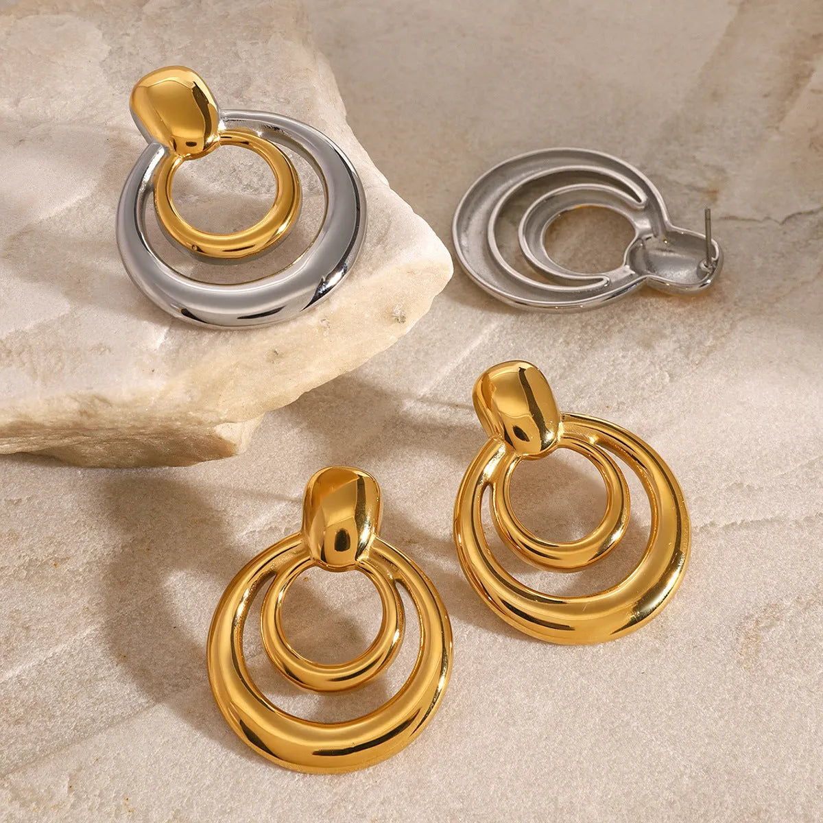 Golden electroplated titanium steel hollow geometric stud earrings showing double layer round design