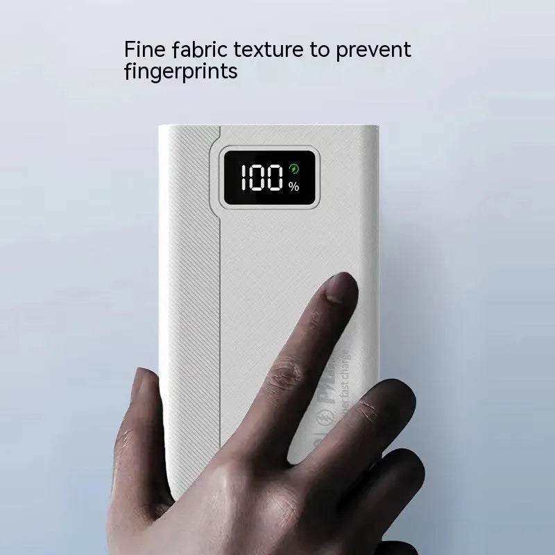 Black and white large capacity power bank with plastic shell showing fast charge support.