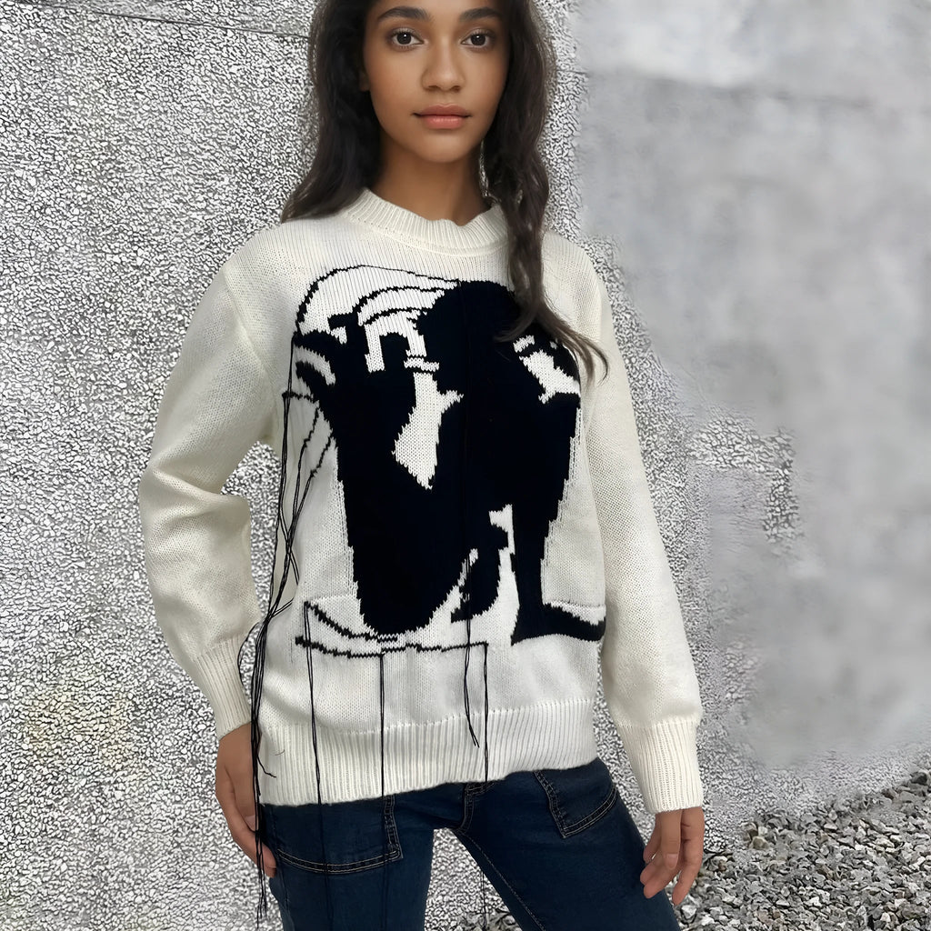 Grey and white women's alpaca wool sweater with tassel detail and abstract pattern.
