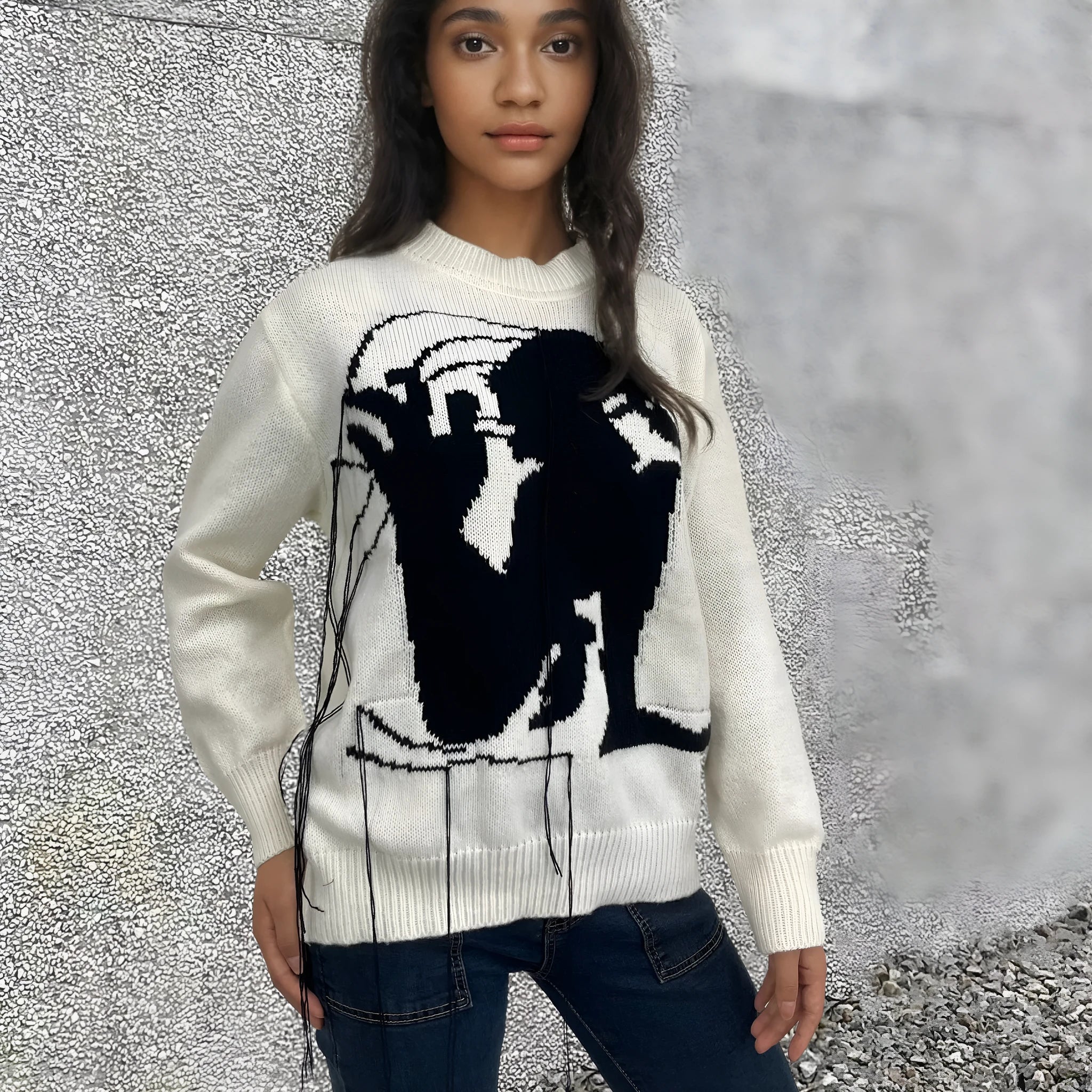 Grey and white women's alpaca wool sweater with tassel detail and abstract pattern.