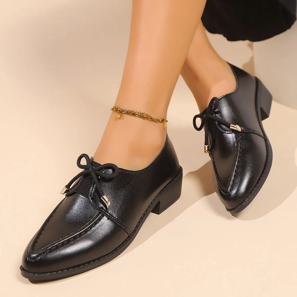 Women's British-style leather-look slip-on shoes with a decorative bow on the front