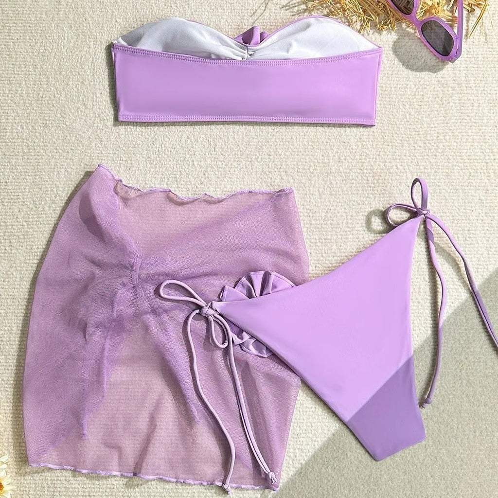Women's pink tube top swimsuit with large 3D flower tie, matching pants and skirt.