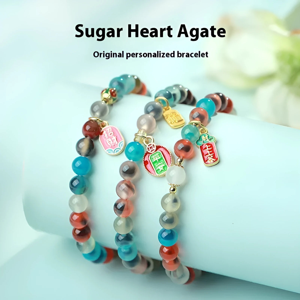 Natural agate and coloured glaze snake bracelet with copper coin charms on a white background.